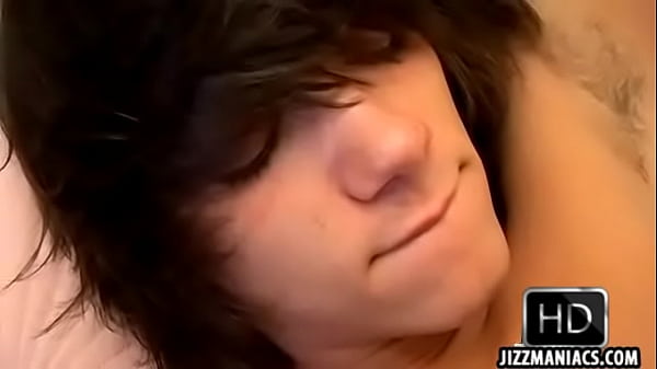 A hot brunette twink is giving erotic head on a bed