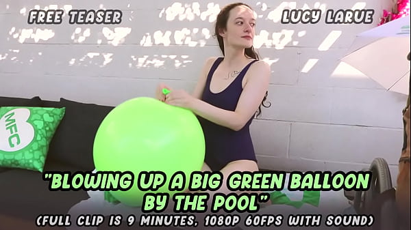 Blowing up a big green balloon by the pool 