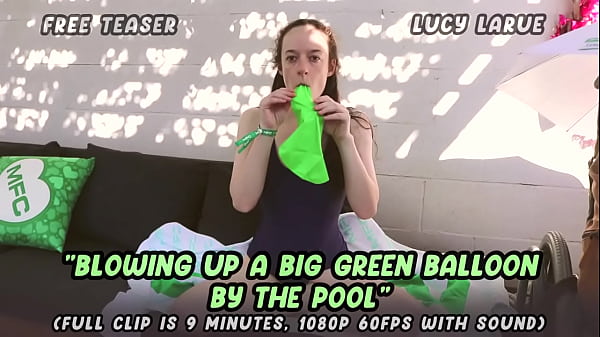 Blowing up a big green balloon by the pool 