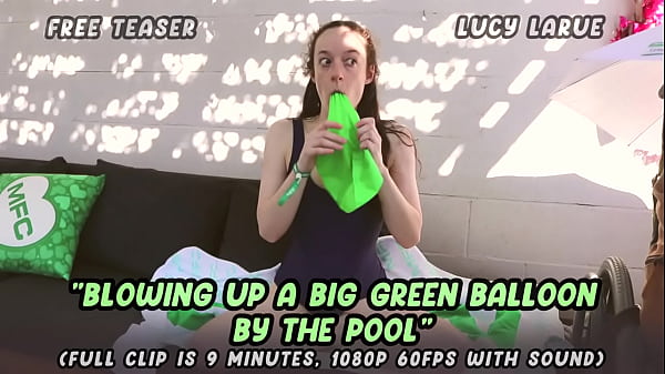 Blowing up a big green balloon by the pool 
