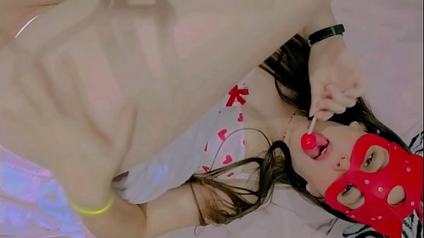 Sucking lollipop lay down on the bed and masturbation