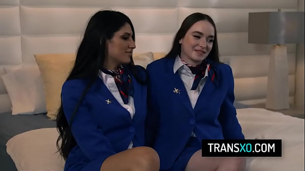 Sexy shemale and female flight attendants fuck in the hotel's bed 