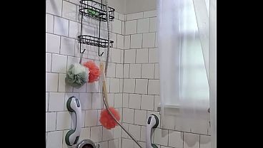 Caught my "stepmom" enjoying the water coming out of the shower head and she masturbates 