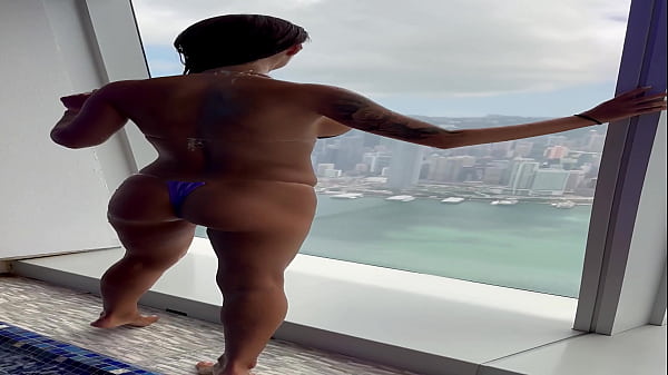 Monika fox in purple bikini swims in pool & poses by window against background of city free 