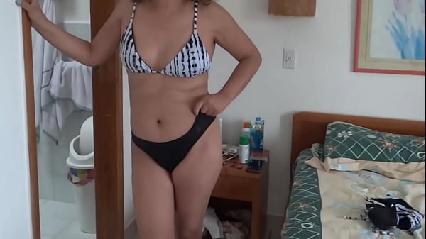 Beautiful stepmother on the beach putting on a bikini showing off looking for some guy