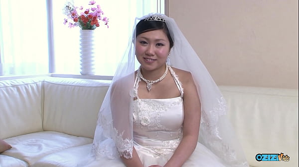 The_new asian wife_is still_dressed_in her_wedding_gown when someone visited her