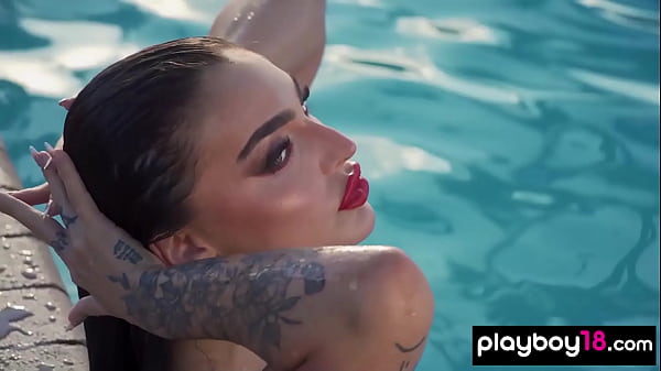 Bombastic naked brunette babe swimming in the pool 